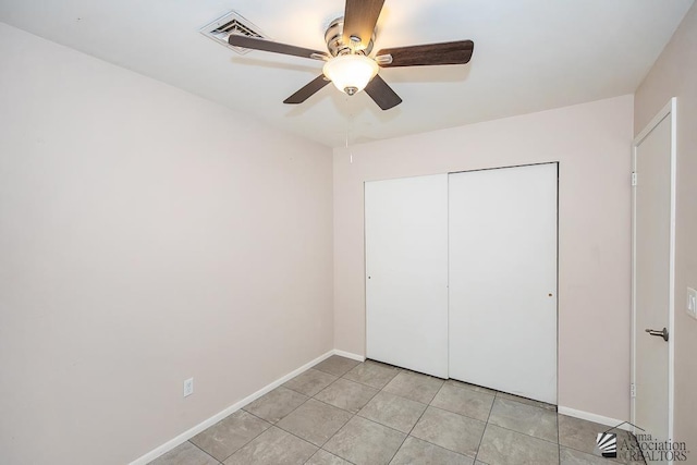 1508 W 14th St, Yuma, AZ 85364 - unfurnished bedroom featuring baseboards, a closet, ceiling fan, and light tile patterned floors