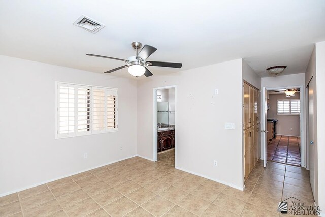 1508 W 14th St, Yuma, AZ 85364 - empty room featuring a ceiling fan, light tile patterned flooring, and baseboards
