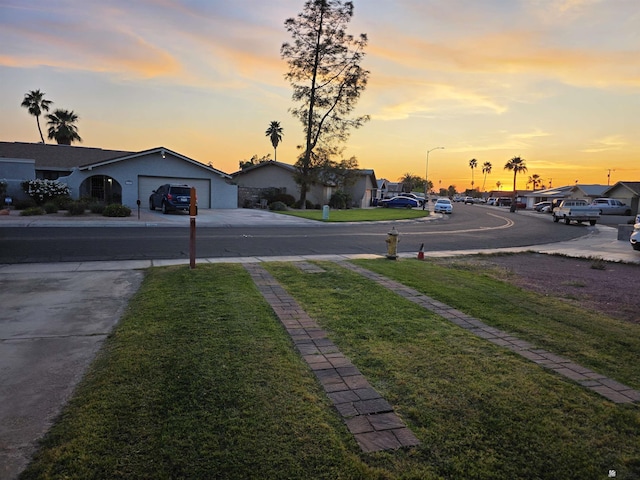 1904 E 26th Pl, Yuma, AZ 85365 - view of asphalt road with sidewalks, street lights, and a residential view