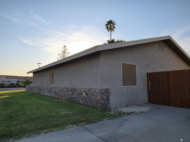 1904 E 26th Pl, Yuma, AZ 85365 - view of property exterior featuring stucco siding, a patio area, and stone siding