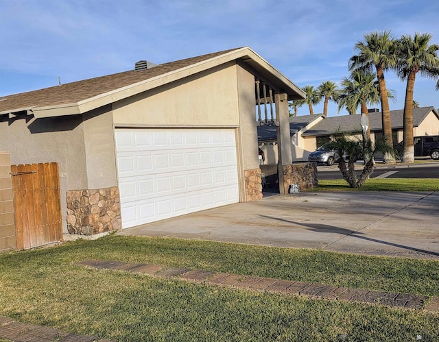 1904 E 26th Pl, Yuma, AZ 85365 - view of property exterior featuring stone siding, stucco siding, driveway, and a yard