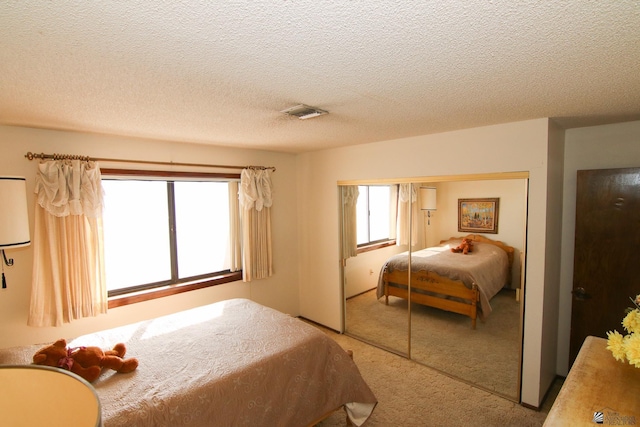 634 E 25th Pl, Yuma, AZ 85365 - bedroom with a closet, carpet flooring, a textured ceiling, and visible vents