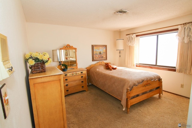 634 E 25th Pl, Yuma, AZ 85365 - bedroom with light carpet, a textured ceiling, and visible vents