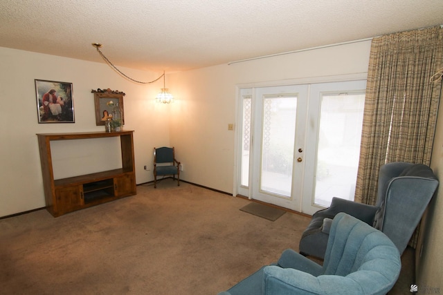 634 E 25th Pl, Yuma, AZ 85365 - sitting room featuring carpet floors, french doors, and a textured ceiling