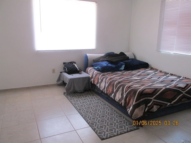 bedroom with light tile patterned floors