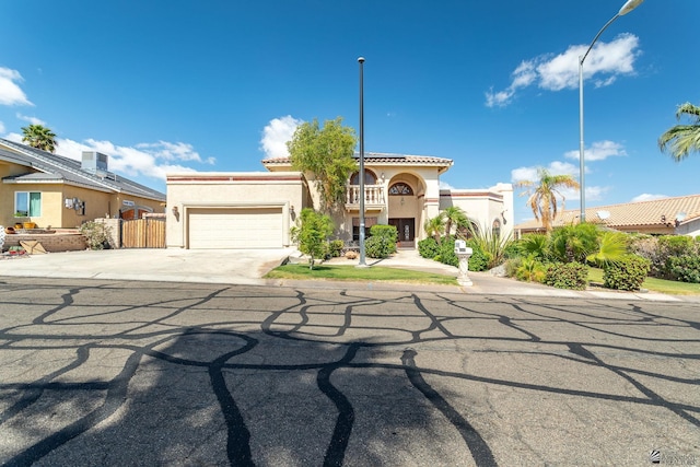 10538 S Del Vista Dr, Yuma, AZ 85367 - mediterranean / spanish house featuring stucco siding, an attached garage, concrete driveway, and a tiled roof