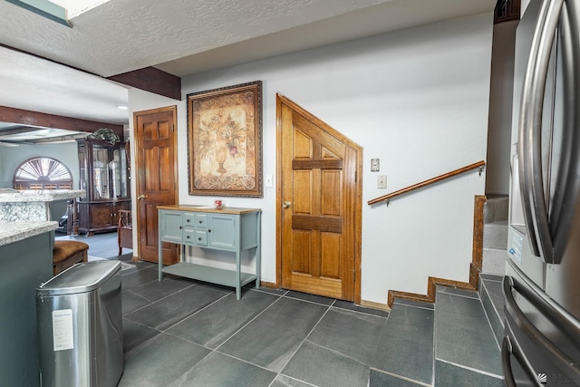 10538 S Del Vista Dr, Yuma, AZ 85367 - stairway with a dry bar, a textured ceiling, and baseboards
