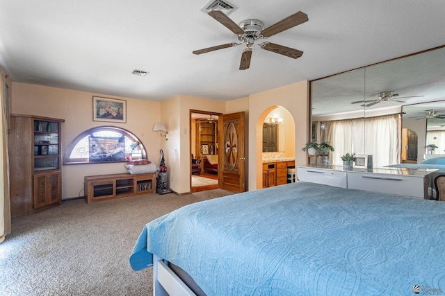 10538 S Del Vista Dr, Yuma, AZ 85367 - bedroom with carpet flooring, arched walkways, ensuite bathroom, and ceiling fan
