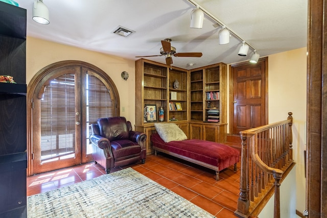 10538 S Del Vista Dr, Yuma, AZ 85367 - living area with track lighting, tile patterned flooring, ceiling fan, and an upstairs landing