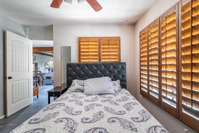 10538 S Del Vista Dr, Yuma, AZ 85367 - bedroom with multiple windows, a ceiling fan, and dark tile patterned flooring