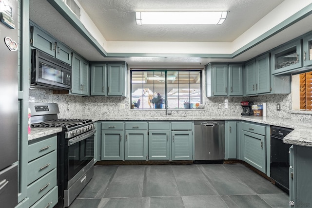 10538 S Del Vista Dr, Yuma, AZ 85367 - kitchen with appliances with stainless steel finishes, a sink, backsplash, and light stone countertops