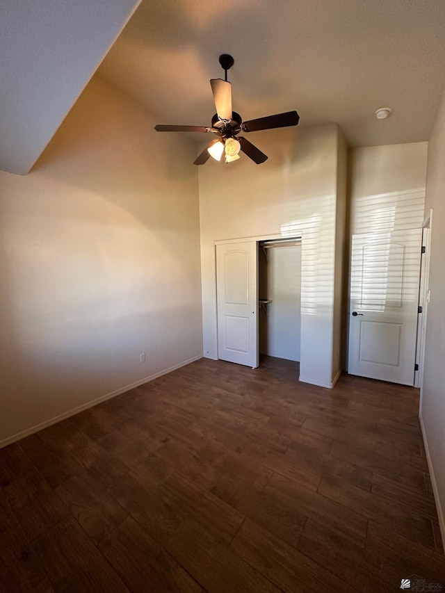 4441 W 13th St, Yuma, AZ 85364 - unfurnished bedroom with a closet, baseboards, dark wood-type flooring, a ceiling fan, and vaulted ceiling