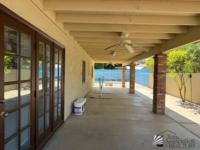 1671 W Del Oro Ln, Yuma, AZ 85364 - fenced backyard with french doors, a patio area, and ceiling fan