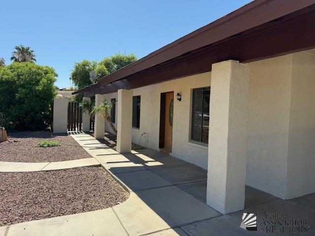 1671 W Del Oro Ln, Yuma, AZ 85364 - view of home's exterior with stucco siding and a patio
