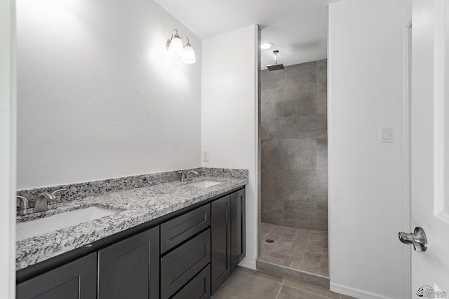 10752 E 45th Pl, Yuma, AZ 85367 - bathroom featuring tiled shower, double vanity, and tile patterned flooring