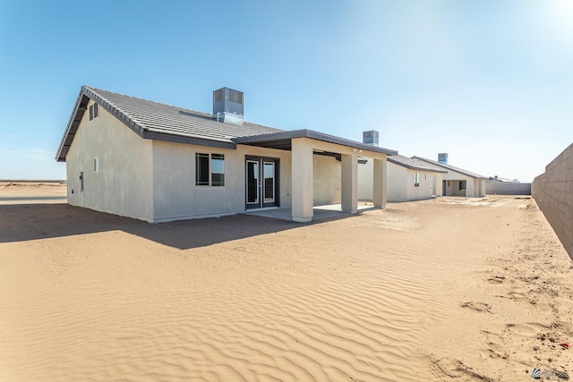 10752 E 45th Pl, Yuma, AZ 85367 - back of property featuring french doors, a tile roof, stucco siding, and a patio area