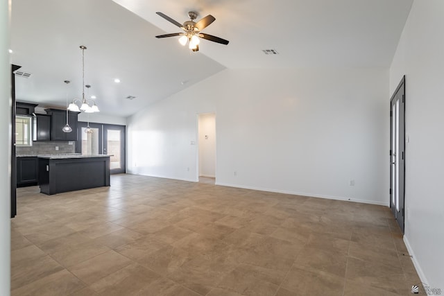 10752 E 45th Pl, Yuma, AZ 85367 - unfurnished living room featuring a chandelier, ceiling fan, and vaulted ceiling
