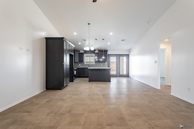 10752 E 45th Pl, Yuma, AZ 85367 - kitchen with light countertops, a chandelier, tasteful backsplash, open floor plan, and a kitchen island