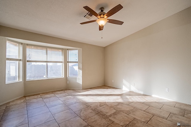 unfurnished room with visible vents, ceiling fan, and lofted ceiling