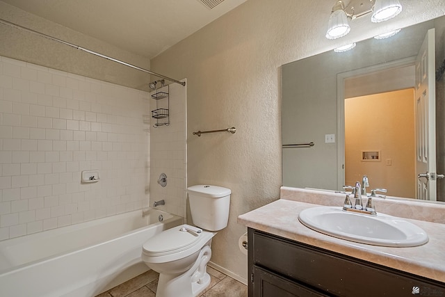bathroom with vanity, tile patterned flooring, a textured wall, toilet, and bathtub / shower combination