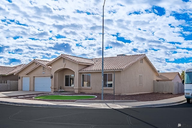 6231 E 40th Pl, Yuma, AZ 85365 - view of front of home with a tiled roof, a garage, driveway, and stucco siding