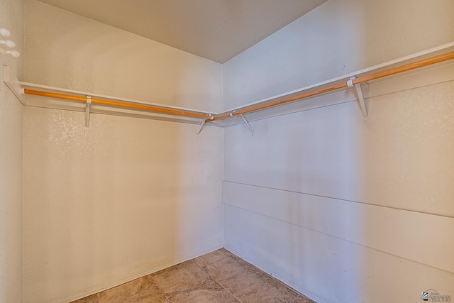spacious closet featuring light tile patterned flooring