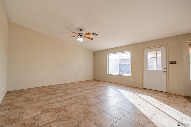 unfurnished room featuring visible vents and a ceiling fan