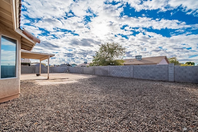 view of yard with a fenced backyard and a patio