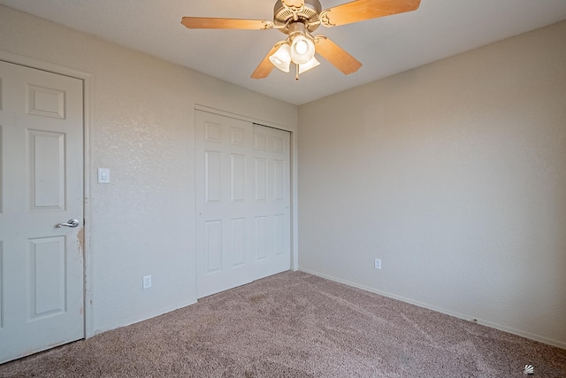 unfurnished bedroom featuring carpet floors, ceiling fan, baseboards, and a closet