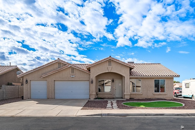 6231 E 40th Pl, Yuma, AZ 85365 - view of front of property featuring a tiled roof, an attached garage, stucco siding, and driveway