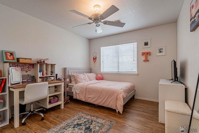 11608 E 26th Ln, Yuma, AZ 85367 - bedroom featuring wood finished floors, an office area, baseboards, a ceiling fan, and a textured ceiling