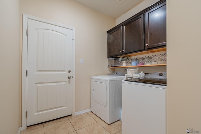 6533 E 35th Pl, Yuma, AZ 85365 - laundry area featuring cabinet space, washer and clothes dryer, light tile patterned floors, and baseboards