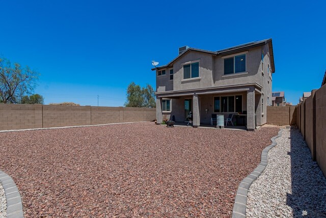 6533 E 35th Pl, Yuma, AZ 85365 - back of property with a fenced backyard, stucco siding, and a patio