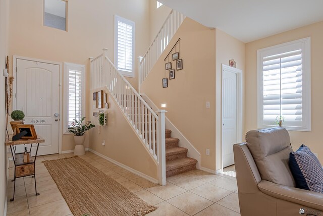 6533 E 35th Pl, Yuma, AZ 85365 - foyer entrance with stairway, light tile patterned flooring, a towering ceiling, and baseboards