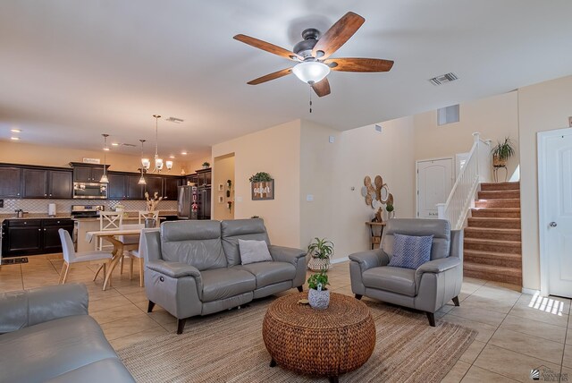 6533 E 35th Pl, Yuma, AZ 85365 - living area featuring light tile patterned floors, a ceiling fan, and stairway
