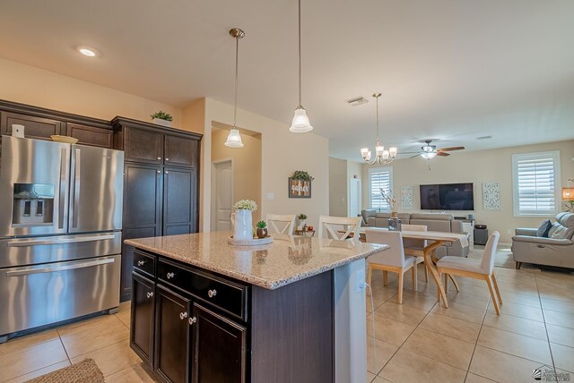 6533 E 35th Pl, Yuma, AZ 85365 - kitchen with stainless steel fridge, light tile patterned floors, open floor plan, and plenty of natural light