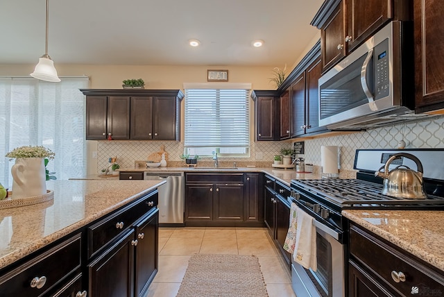 6533 E 35th Pl, Yuma, AZ 85365 - kitchen featuring stainless steel appliances, a sink, light stone counters, light tile patterned flooring, and tasteful backsplash