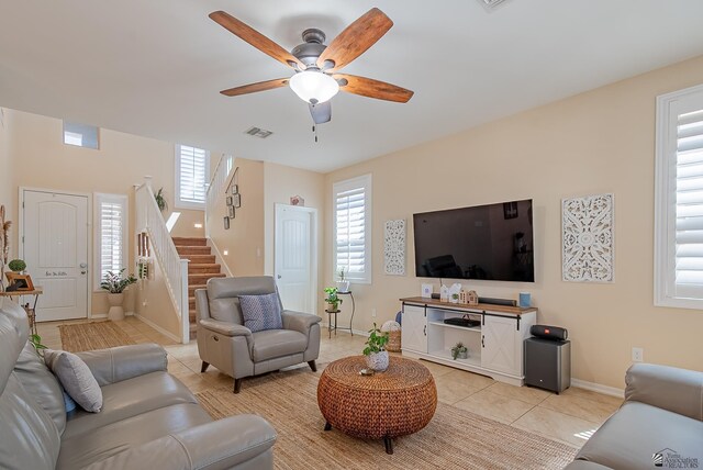 6533 E 35th Pl, Yuma, AZ 85365 - living area featuring light tile patterned floors, ceiling fan, stairway, and plenty of natural light