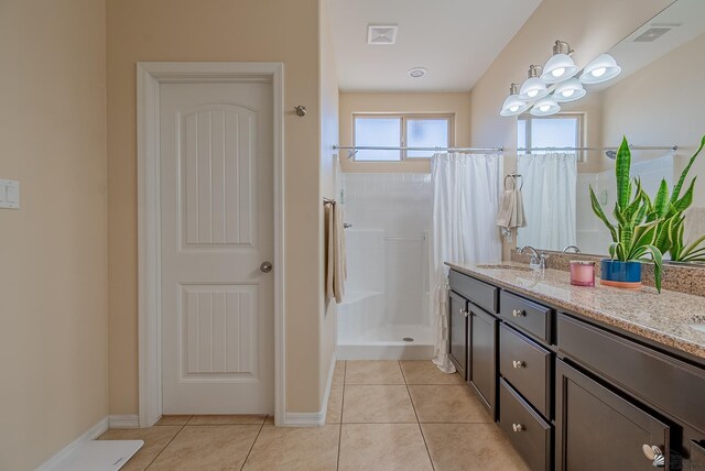 6533 E 35th Pl, Yuma, AZ 85365 - full bath featuring a shower with shower curtain, double vanity, tile patterned flooring, and baseboards