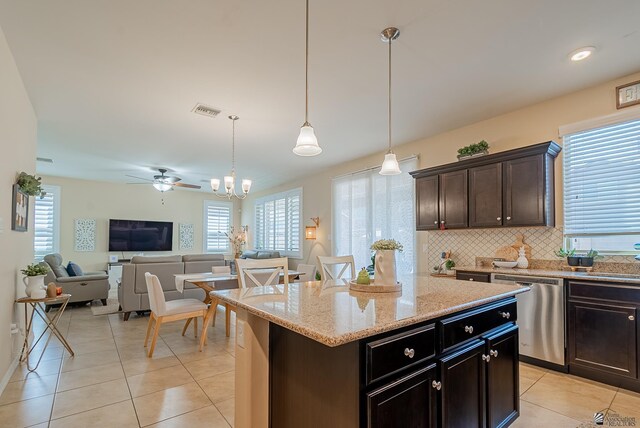 6533 E 35th Pl, Yuma, AZ 85365 - kitchen featuring stainless steel dishwasher, light tile patterned floors, open floor plan, and plenty of natural light