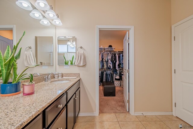 6533 E 35th Pl, Yuma, AZ 85365 - bathroom featuring vanity, tile patterned floors, baseboards, and a spacious closet