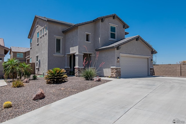 6533 E 35th Pl, Yuma, AZ 85365 - view of front of property featuring driveway, stucco siding, an attached garage, and stone siding
