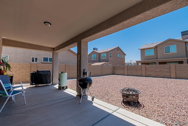 6533 E 35th Pl, Yuma, AZ 85365 - fenced backyard with area for grilling, a patio, and a fire pit