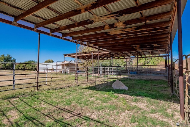 view of yard featuring an enclosed area, an outdoor structure, and an exterior structure