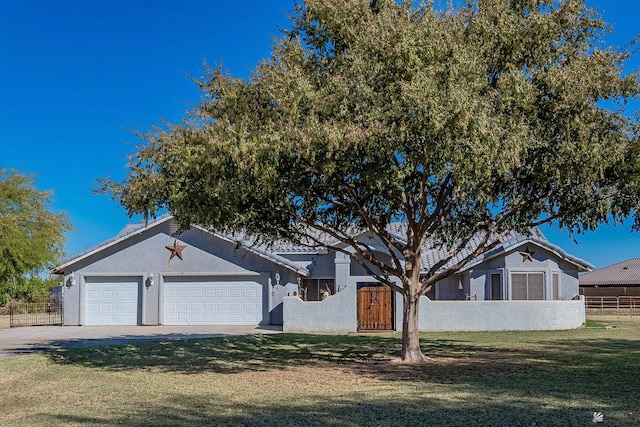 single story home featuring a tiled roof, a garage, fence, concrete driveway, and stucco siding
