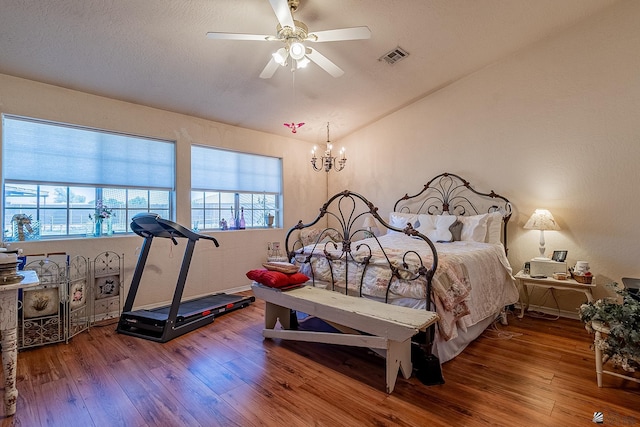 bedroom featuring visible vents, a ceiling fan, and wood finished floors