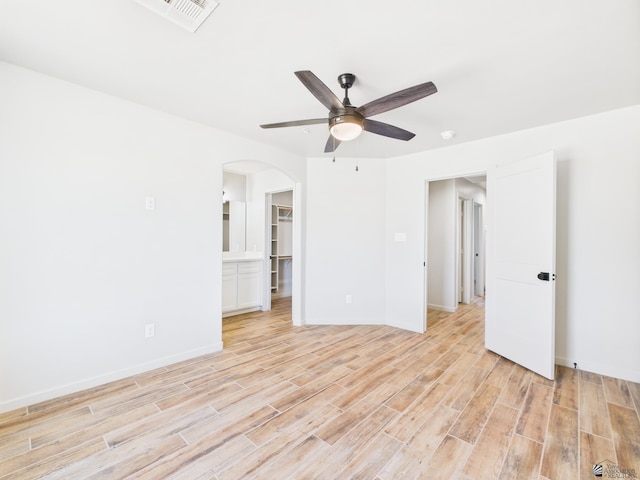 12116 E Calle Del Cid Unit B, Yuma, AZ 85367 - spare room featuring arched walkways, ceiling fan, light wood-style floors, and a smoke detector