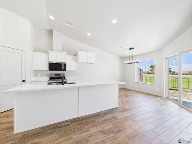 12116 E Calle Del Cid Unit B, Yuma, AZ 85367 - kitchen featuring stainless steel appliances, light countertops, a center island with sink, white cabinets, and light wood-type flooring