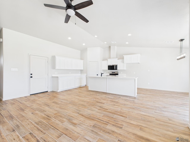 12116 E Calle Del Cid Unit B, Yuma, AZ 85367 - unfurnished living room featuring ceiling fan, light wood finished floors, high vaulted ceiling, and recessed lighting