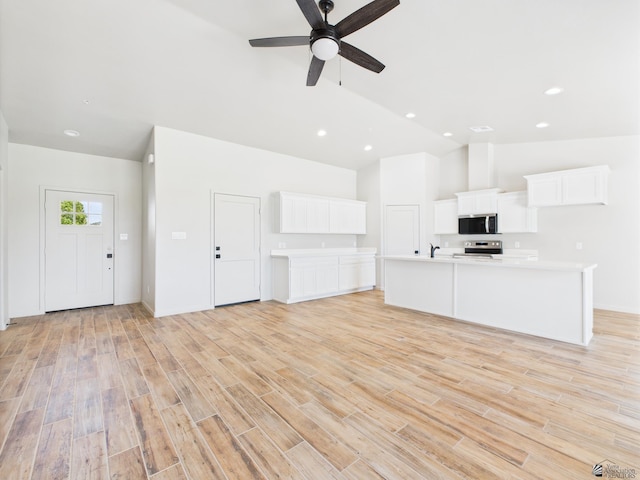 12116 E Calle Del Cid Unit B, Yuma, AZ 85367 - unfurnished living room with light wood-style flooring, ceiling fan, high vaulted ceiling, and recessed lighting